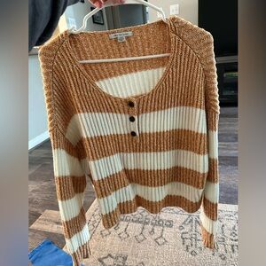 Orange and white striped cropped American Eagle sweater.